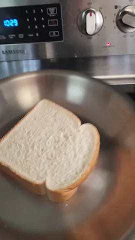 double sided grilled cheese on a stainless steel pan