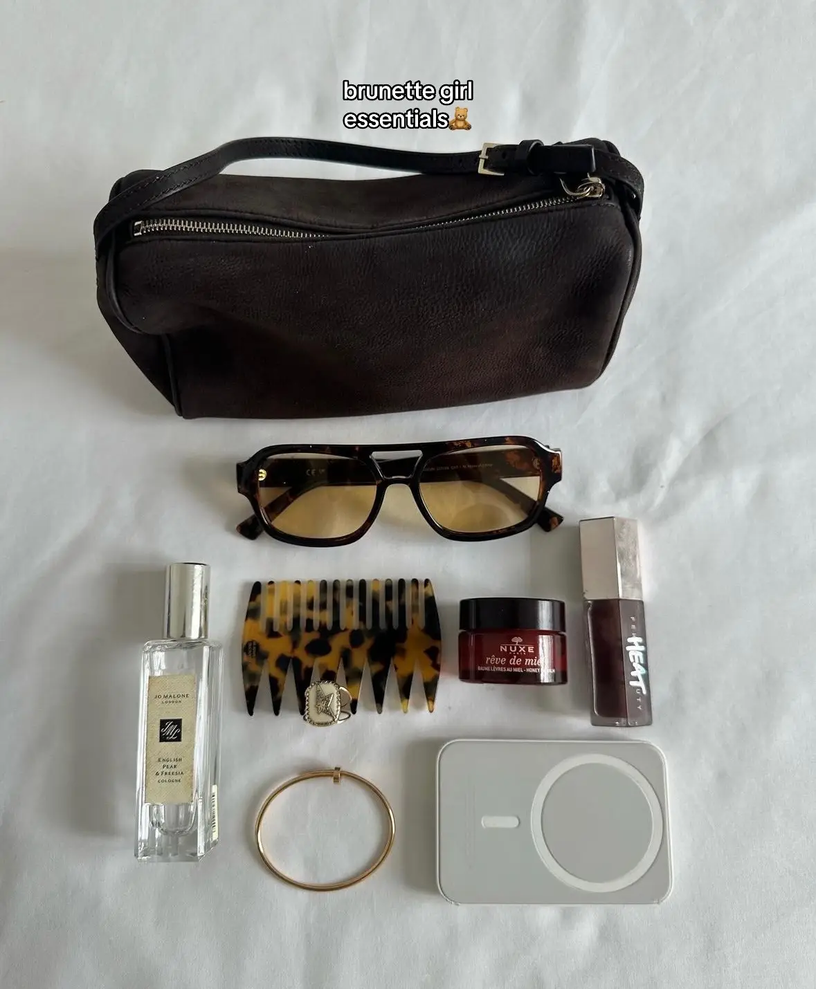 girl essentials: what’s in my bag🧸🍓🐈‍⬛ brands: @Jo Malone London @Fenty Beauty @pradabeauty @Gisou @ChanelOfficial @Gucci  #whatsinmybag #makeupproducts #makeup #purse #bag #brunette #strawberryblonde #fyp #foryoupage 