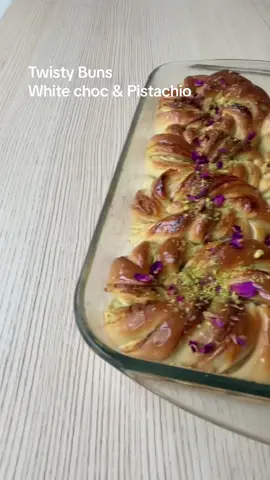 7g instant yeast  310ml lukewarm milk OR 260ml milk and 1 x egg  30g sugar  85g melted butter (salted)  480g bread flour  Filling: 100g white chocolate melted with 40g butter  100g blended pistachios (leave some aside for topping)  Topping: Honey (brushing)  Some of pistachios  Dried rose petals (optional)  For the dough: Melt your butter (45 seconds microwave) and warm your milk (1 min to 1.5 min in microwave)  Mix all the dough ingredients together in the order listed, IF you’re using egg add it in after the flour, mix till combined and knead on a well floured surface for 5-10min. Cover and rest for 60 min. While it’s resting blend your pistachios, get your oven dish ready (I used a glass Pyrex and greased it with butter)  When it’s nearly been 60min melt your chocolate and butter. Roll your dough out into a rectangle about 1/2 cm thick, spread with chocolate mix and top with pistachios. Fold as shown in the video and then roll out again. Slice into 8 equal rectangles using a pizza cutter as shown in video and then slice 3 lines inside each section but not all the way leave about 1/2 inch from the top. Shape all 8 as shown in the video, add to your dish and cover and rest for 30-40 min, when there’s about 20 min left of resting preheat your oven to 180C  Bake on middle shelf for 20-25 minutes. As soon as they come out brush generously with honey, top with pistachios and rose petals  Don’t forget to follow along for more  Enjoy D 🫶 #bread #buns #chocolate #pistachio #fyp 