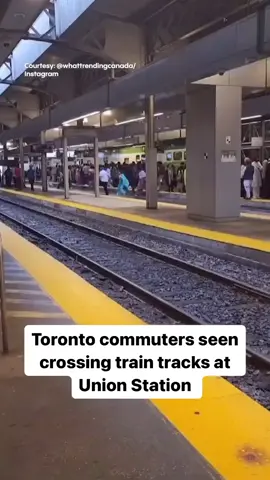 Metrolinx is warning passengers never to cross train tracks as a video of a large crowd of Toronto commuters doing just that goes viral.