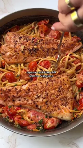 two of my favorite foods combined 🫶🏻  RECIPE (serves 2) 8 oz linguine 2 tbsp olive oil, divided (plus more for pasta) 1 lb salmon Seasoning of choice 2 ½ cups cherry or grape tomatoes 2 shallots, finely chopped 4 cloves minced garlic 2 tbsp chopped Calabrian Chilis, from a jar 2 tbsp butter 1 cup heavy cream ¼ cup chopped basil ¼ cup chopped parsley 1. Bring a pot of salted water to a boil. Add the linguine and cook al dente, according to package. Drain, toss in olive oil to prevent sticking, and set aside.  2. Season your salmon with blend of choice (I used garlic and herb). Heat 1 tbsp olive oil in the pan on medium-high. Add the salmon salmon skin up, and cook for 4 minutes on each side. Remove from pan, and set aside. 3. Add remaining 1 tbsp olive oil to the pan on medium heat. Add tomatoes and shallots, season with salt, and cook for about 6-7 minutes until tomatoes have softened. Add the calabrian chilis, butter, and cream. Mix together and bring to a simmer, and cook for 2-3 minutes until sauce has thickened (you can press down on the tomatoes to soften them more). 4. Turn the heat to low, and then mix in the parsley and basil. Mix in your cooked linguine, and then top with salmon. Serve warm!  #recipes #dinnerrecipes #mealideas 