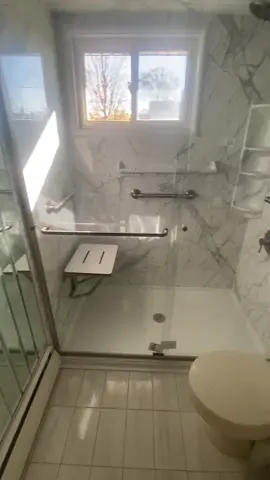 Check out this beautiful Calcutta marble handicap-accessible walk-in Shower! Featuring a cushioned flip-up seat, four-shelf corner caddy, and ample chrome finished grab bars for maximum safety! If you need a safe & accessible shower, you don't have to sacrifice a beautiful modern design! Call us today at 516-888-6862 for your free safe shower remodel consultation today, or visit us online at www.bathroomprosnyc.com #BathRemodel #BathroomRemodel #SafeShower #AccessibleShower #BathroomProsNYC