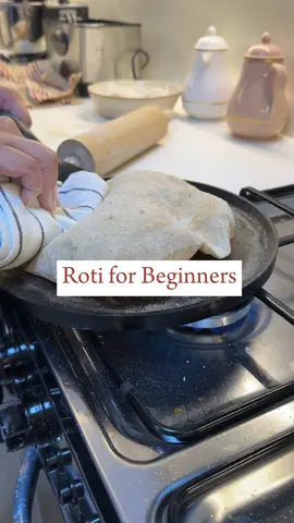 Roti for beginners  I’ve always struggled to make proper rotis but after a lot of experimenting and trial and error, I find this method of forming atta has helped me achieve fluffy delicious rotis. Everyone has their own way and that’s ok!  Ingredients 4 cups chakki atta (any brand)  1 tsp salt  240 ml of warm water  Directions:  1. In a large bowl, pour 4 cups of atta along with salt. Roughly mix it with your hands  2. Slowly add half the warm water to the flour and slowly mix with your hands. I like to squeeze the atta and water in my hands which helps form the dough (warm water will ensure a softer dough. If you want fluffy rotis then your dough needs to be soft. Hard dough will result in hard rotis that don’t fluff up!)  3. Once the water has been mix well and there’s still dry atta left over, I add a little bit more water slowly and repeat step 2  4. Once the dough has formed but it is looking sticky, I cover the dough and let it rest for 5-10 mins. Resting is essential as it will help the gluten relax which will make it much easier to knead the dough into a smooth texture. If you skip this step then you will be left with sticky wet dough.  5. After resting, I dip my hands into warm water ensuring the front and back of my hand is wet. I then begin kneading the dough. I pull the edges into the middle and punch the dough with the back of my hands. Keep wetting your hands when needed, this helps prevent the dough from sticking to your hands and also make sure the dough remains moist.  6. Once you have a smooth dough, transfer to a clean dish, wet your hands and just form a clean smooth dough and keep the top wet with some warm water, this prevents discolouration. Cover with cling film.  7. Let the dough rest for at least 40 mins in the fridge before using.  8. Follow for part 2 on how to roll and cook the rotis!  #roti #rotiforbeginners #atta #chappati 