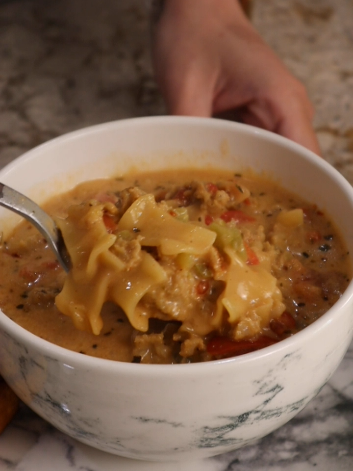 Creamy Lasagna Soup You will need: 1 box of Lasagna Hamburger Helper $1.25 2 rolls of sausage (7 oz each) $2.50 1 can of diced tomatoes $1.25 1 bag of frozen seasoning blend $1.25 1 carton of beef broth $1.25 4 ounces of cream cheese $1.25 Garlic Bread (side, optional) $1.25 In a large pot over medium high heat brown and crumble sausage.  Add frozen seasoning blend and sautee briefly.  Add 4 ounces of cream cheese cut into cubes, and 1 can of undrained diced tomatoes (pro tip, if you can find fire roasted, or italian seasoned diced tomatoes, use those)  Once the cream cheese is almost fully melted, add beef broth and for a thinner soup you can add up to 2 cups of water.  For a thicker soup, don't add water.  Bring this up a boil, then add Hamburger Helper noodles and seasoning mix.  Reduce to low, cover and simmer for 10 minutes stopping to stir twice.  Taste for seasonings, add salt and pepper if needed, and if desired add red pepper flake and italian seasoning.    Serve with garlic bread on the side if desired.   Enjoy! #dollartree #dollartreefood #dollartreegroceries #dollartreerecipes #dollartreedinners #onepotdinner #soup #lasagnasoup #hamburgerhelper #weeknightdinner #budgetfriendlymeals