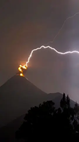 Marvel at the awe-inspiring power of nature with volcanic lightning at Volcán de Fuego in Guatemala 🌋⚡️ Volcanic lightning is different from the lightning you see in a regular thunderstorm, and is caused by collisions between ash particles or fragments within the plume, creating static electricity. 🎥 @maiduspace on IG #guatemala #volcano #lightning #volcanoeruption