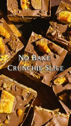 No Bake Crunchie Slice Recipe - 300g Digestive Biscuits (Fine Crumb) - 200g Sweetened Condensed Milk - 100g Unsalted Butter (Melted) - 6 Large Crunchie Bars (Roughly Chopped, 4 for inside the bar and 2 for on top).  - 250g Milk Chocolate  - Grease and line an 8 inch square pan. Set aside. - Either using a food processor or a ziplock bag and a rolling pin, blitz/crush the digestive biscuits until you have a fine crumb. - Place the crumb into a medium bowl. Pour the melted butter and condensed milk in then mix until combined. - Fold in 4 of the chopped Crunchie bars into the mixture until evenly combined. - Pour the mixture into your prepared pan and spread evenly using a spatula or your hands. - Place the chocolate in a small microwaveable bowl, microwave in 30 second bursts (stirring in between) until melted. - Pour the chocolate over the Crunchie base and smooth over with a spatula. - Place the remaining chopped Crunchie bar evenly over the top.  - Refrigerate for 2-3 hours or until set. - Remove from the pan and cut into as many pieces as you like. - Enjoy! #nobake #crunchie #EasyRecipe #Love 