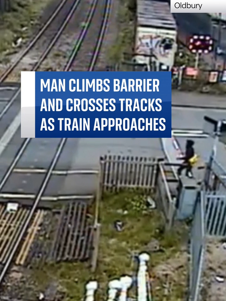 A man has been caught climbing the barrier and going onto the tracks at a railway crossing as a train quickly approaches. #danger #railway  #train