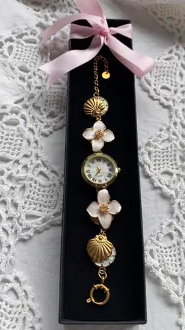 Our signature Flower & Shell Charm Watch👼🏻💕 #vintagewatch #gemstonewatch #classicjewelry #pearlwatch #goldjewelery #jewelry #vintagevibes #oldmoney #flowerwatch #coquette #mermaidcore #fairytale #abalone #classic #elegant