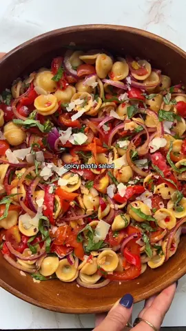 spicy pasta salad! recipe: RECIPE  8 oz orecchiete 3 red bell peppers 1 1/2 cups quartered cherry tomatoes 1/2 cup thinly sliced red onion 1/3 cup thinly sliced basil 1/4 cup roughly chopped parsley 1/2 cup shaved Parmesan 3 tbsp Calabrian chiles Dressing 2 cloves garlic, finely chopped 1 tbsp Dijon mustard 1/2 tsp honey 4 tbsp red wine vinegar 3 tbsp olive oil 1/4 tsp salt 1. Preheat oven to 425 F. Slice peppers in half lengthwise, and remove the insides and seeds. Place face down on a parchment paper lined baking sheet, and bake for 20-30 minutes until peppers are tender and beginning to char in spots. Let cool, and then cut into thin, 2” slices. You can remove the skin if you want, but I left mine on and just removed anything that was too charred. 2. While peppers are cooking, prepare pasta al dente, according to package. Drain, and let cool, tossing in a little bit of oil to prevent sticking. 3. To prepare dressing, add everything to a small bowl or jar and whisk with a fork until smooth. Add pasta, peppers, tomatoes, onion, basil, parsley, shaved Parmesan, and Calabrian chilis to a large bowl. Add the dressing, and toss until everything is evenly coated. Serve immediately or refrigerate for later! #cooking #recipes #infertility #ttc
