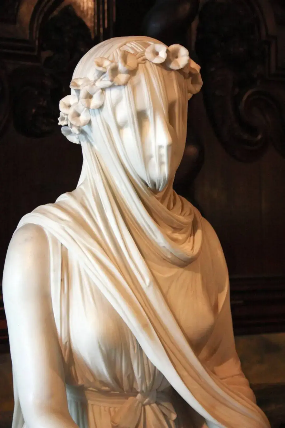The sculptures depict the veiled priestess of Vesta - the Vestal Virgin.  Vesta is the Roman goddess and guardian of the sacred fire.  Their thinnest veil is made so skillfully that even light passes through.  In addition to the fact that Rafael Monti created several unique veiled sculptures, he also revealed the secrets of the most complex technology for their creation.  In his work, the master used a special type of marble, which has two layers of different densities.  The top layer of this marble has a lower density compared to the bottom.  The finest processing of the top layer allowed the master to create the effect of transparency of the veil.  What’s unique is that all the work on processing this marble was done by the craftsman manually, without the use of automated technologies.  Earlier craftsmen probably also used marble with a similar structure.  The rarity of the material and the complexity of production can explain the small number of sculptures with a marble veil. #rafael #monti #sculpture #art #romanempire 