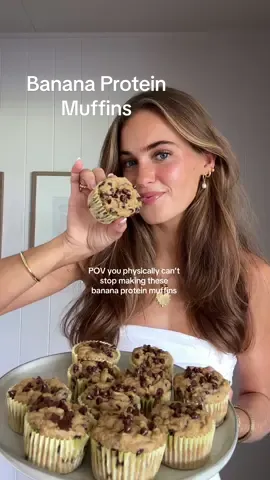 Banana Protein Muffins recipe below ✨ The most delicious banana muffin recipe that is perfect for a healthy snack or treat! Also love that it has added protein into it 🤍 Super quick and easy, give it a try!  Dress is from @Revolve ✨ *makes 12 regular sized muffins* Ingredients: -3 bananas  -2 eggs  -3/4 cup greek yogurt  -1/4 cup maple syrup  -1 tsp vanilla  -2 cups oat (or oat flour)  -1 scoop vanilla protein powder -2 tbsp baking powder  -1 tbsp baking soda  -dash of cinnamon  -pinch of salt  -chocolate chips (measure with your heart 🫶🏼)  Instructions: 1. Preheat oven to 350F. Mash bananas in a bowl and add all wet ingredients. Mix, but don’t over mix, until combined.  2. Add your oats to a blender and blend to make oat flour. Pour into the banana mix along with all the other dry ingredients. Mix (again don’t over mix!) until just combined. Add chocolate chips and fold into batter.  3. Scoop batter into a prepared muffin tin and top with more chocolate chips. Pop into the oven for 14-18 minutes until baked through. Enjoy!  #bananabread #bananamuffins #muffin #highprotein #healthyrecipes #EasyRecipes #healthylifestyle 