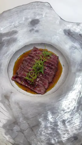 Beef Tataki  Ponzu sauce:  1 1/2 tbsp sake 2 tsp mirin 2 tbsp rice wine vinegar  1/4 (60gr)cup soy sauce  2 tbsp water  2 tbsp fresh lemon juice Mix it all and keep it in the fridge to chill.  If you have any preferences, you can add more vinegar and a bit of sesame oil!  Wagyu beef sirloin:  Trim the excess fat from the steak and season with salt. In a hot nonstick pan, sear the steak on one side for about 20 seconds, flip and cook on the other and long sides. Let the steak to rest for 5 to 8 min. Take a few green onions and julienne the green part. Dip the julienned green onion in a small bowl of ice and water. Stir the green onion around with your finger to unstuck them from each other. Let it stand in for about 15 minutes. Drain the green onions on a paper towel. Slice the beef as thinly as you can!  It's time to plate the beef now! When plating the meat, you can arrange it on the plate one on top of the other, leaving some space between each piece. Alternatively, you can plate the beef as you like, depending on the size and style of your plate. Drizzle with ponzu sauce and garnish with julienned green onion, pinch of togarashi spices, and sesame seeds. Serve with additional ponzu sauce.  The nutritional goodness of Wagyu beef sirloin Tataki! Packed with high-quality protein, healthy monounsaturated fats, omega-3 and omega-6 fatty acids, and essential vitamins and minerals like B vitamins, iron, zinc, and selenium, this dish offers a nutritious dining experience. Remember to enjoy it in moderation alongside vegetables and whole grains for a balanced meal.  . . #newtrend #newpost #newrecipe #newreel #chef #cheflife #privatechef #viralvideo #food #foodtiktok #yummy #foodheaven #chefsoftiktok #foodporn #wagyu #wagyubeef #FoodLover #chefs 