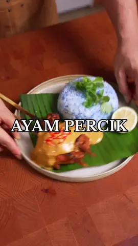 🇲🇾 Ayam Percik  I loved and enjoyed making this dish. It uses such a rich blend of spices and is served alongside (and even basted with) a rich gravy made from coconut cream. It's incredibly homey, and even though I wasn't raised in that country, I can imagine the warm feeling many Malaysians feel when enjoying this meal. I highly recommend you try it! INGREDIENTS: Paste: - 12 asian shallots - 6 cloves of garlic - 1 inch ginger - 1 inch turmeric - 1/4 cup macadamia nuts - 1/4 cup coriander seeds Meat: - 6 pcs chicken thigh leg - 1 tsp turmeric powder - Salt to taste Gravy/Sauce: - 1 pack of coconut cream - salt to taste - 1 tsp coriander powder - 1/4 palm sugar blocks, chopped - 2 stalks of lemongrass - a spoonful tamarind paste - a spoonful of chili paste Blue Rice: - 1/2 cup coconut cream - 1 stick of pandan - handful of butterfly pea flowers INSTRUCTIONS: - Score your chicken thigh leg's to ensure even cooking and set aside. - Add your shallots, garlic, ginger, turmeric stalks, macadamia nuts and coriander seeds into a blender along with 1/2 a cup of water. Blend til combined. - In a large bowl, place your scored chicken thigh leg's and add half of the blended marinade. Add some turmeric powder for color and mix well until the marinade is fully integrated with the chicken. Skewer the chicken and set aside. - In a hot pan, place the remaining marinade. Add in some coconut cream and turmeric powder for color. Additionally, add in tamarind paste, chili paste, and a few slices of palm sugar blocks. Mix well and allow to simmer. Once simmering and combined, add your chicken thigh leg's back and baste the liquid onto the chicken. - In a hot grill or in an oven, add your marinaded chicken and let cook til desired doneness. While cooking, baste the chicken with the liquid to add extra flavor. - To make the blue rice, in a pot add in your uncooked rice, butterfly pea flowers, a stick of lemongrass and coconut cream. - Add your blue rice on a plate, and your cooked ayam percik. Top it off with some of the gravy and sliced birds eye chilies. Serve with a lime and enjoy. #cookingasmr #asmr 