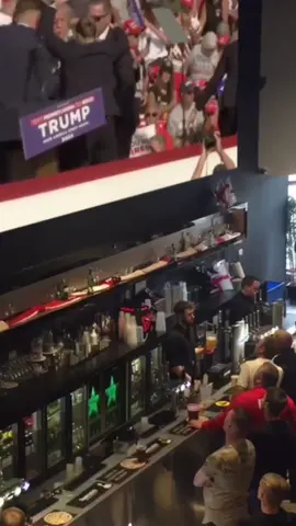 During a live stream of the assassination attempt on Donald Trump at a local bar, the crowd goes wild as President Trump raises his fist to the sky, yelling 