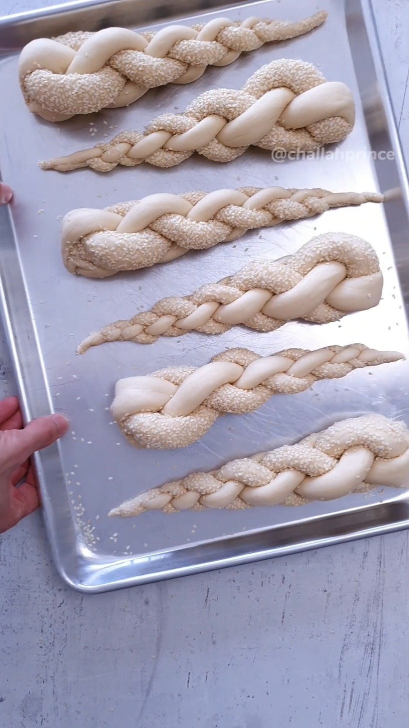 I am thrilled to share these two Challot of Magen David designs! These two creations garnered the most views and engagement on my Instagram, and I couldn't be happier to showcase them in one video. Your support and enthusiasm mean the world to me!  First Challah (Braiding with 4 strands): 750g AP or bread flour 75g Sugar 12g Active Dry Yeast 15g Salt 75g Olive Oil 325g cold Water After the first rise, divide your dough into 24 balls, each weighing 50 grams and measuring 30cm or 12 inches in length. Second Challah (Braiding with 5 strands): kilo AP or bread flour 100g Sugar 15g Active Dry Yeast 20g Salt 100g Olive Oil 430-450g Cold Water  Divide your dough into 30 even pieces. Each piece should be around 52g and 30cm or 12inc. Share this video with your beloved for a Jewish Pride 💙🤍💙 #breadrecipe #challah #jewishfood 