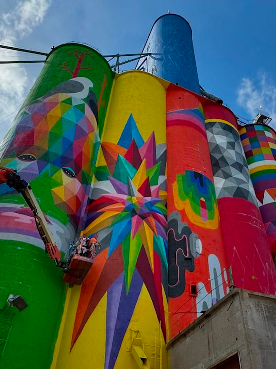 Okuda San Miguel, a renowned contemporary artist, is celebrated for his distinctive blend of colourful geometric patterns and surrealist elements, often exploring existential themes, as seen in his largest mural, 