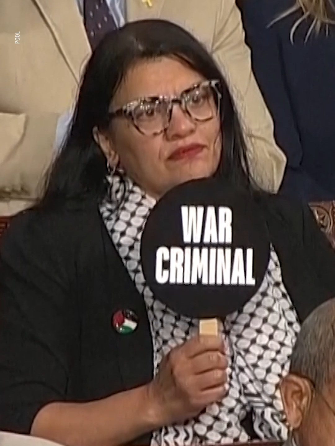 Israeli Prime Minister #BenjaminNetanyahu spoke to a joint session of Congress on Wednesday. Congresswoman #RashidaTlaib—a Democrat from Michigan who has been vocally critical of #Netanyahu and was censured last year over her comments about the Israel-Hamas War—held up a sign that read 