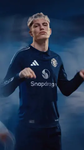 Manchester United and Adidas have released the 24/25 away kit 🥶 United aren’t strangers to blue away kits. This season’s rendition is a nod to those shirts from the club’s past.  The base of the jersey is a dark indigo color that is complimented with a sublimated pattern of M’s all over, in a royal blue hue.  Royal blue is also used for the three squiggly lines that flow along the collar. According to Soccer Bible, these three lines represent the three rivers that flow through Manchester — the Irk, Medlock, and Irwell.  Next, you’ll notice the silver detailing that is utilized for the three stripes, the club badge, sponsor, and the team’s mascot on the back of the collar. It adds a classy finish similar to the gold touch that was added to Chelsea’s kit from the 2012/2013 season — which was also manufactured by Adidas.  As for the names and numbers, United is sticking with the same font from last year.  🎥: @Manchester United  #manumessenger #manutdtiktok #soccerjersey #soccerjerseys #manutdfans #manchesterunitedfc #manunitedfans #manchesterutd 