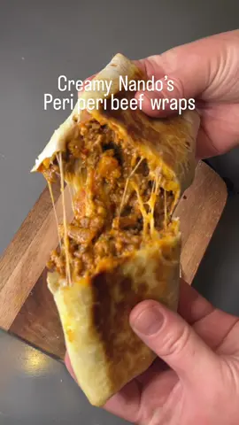 Recipe makes 4 wraps 601 kcal | 38g of protein per wrap Ingredients 500g beef mince(10% fat) 1 red onion, chopped 1 bell pepper ( any colour), chopped 2 large garlic cloves, chopped 250 ml tomato passata 70 ml Nando’s peri peri medium garlic sauce 120 ml water 1 tbsp tomato puree 1 tbsp soft cheese| cream cheese 1 ½ tbsp extra virgin olive oil 3 tsp peri peri seasoning 1 tsp sweet paprika 1 tsp dried parsley salt and pepper to taste 4 large tortilla wraps 100g grated cheese mix ( mozzarella and cheddar) Method 1. Heat 1 tbsp olive oil in a pan, add chopped onion and pepper and cook for 2-3 minutes over a high heat, until softened. Add beef mince and cook until browned, make sure to break it up into little pieces using a spatula. 2. Add chopped garlic and cook for 1 minute, until fragrant. Add tomato puree and all seasonings, stir in well, then add tomato puree, water, Nando’s peri peri sauce, stir in well, cover with a lid and simmer over a medium to low heat, for 15 minutes. Add soft cheese, stir well and cook for another 3-5 minutes. 3. Take your wrap, add some of the grated cheese mix, beef mixture and more of the grated cheese mix, then fold up the wrap. 4. Heat a pan over a medium-high heat, drizzle ½ tbsp olive oil, add the beef wraps and pan fry for 2-3 minutes until golden brown. #dinnerrecipes #lunchtime #quickrecipes #beefwrap #beefrecipe 