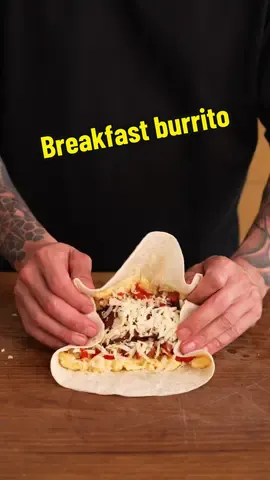 Breakfast Burrito 🌯 Ingredients - 1 red capsicum (bell pepper), sliced - 1 white onion, sliced - 2 large chorizo sausages, diced - 8 slices crispy bacon - 4 potatoes, boiled - 1 tsp cumin - salt and pepper - 8 eggs, beaten - 50ml milk (¼ cup) - 4 large flour tortillas - 180g grated cheese (6.3 oz) - oil for cooking Method 1. In a large cast-iron pan, add a drizzle of oil, then place the cooked half potatoes and press firmly with a spatula to crush and flatten. Cook for 5-6 minutes until golden brown before flipping and cooking for a further 2-3 minutes. Remove and set aside. 2. While the potatoes are cooking, cook your bacon until it's nice and crispy. Once cooked, set aside. 3. In the same pan, add the diced chorizo and sauté for 1-2 minutes before adding the sliced red capsicum, sliced white onions, and seasoning with salt, pepper, and ground cumin. Cook for 5-6 minutes until the peppers and onions have softened and the chorizo has some colour. 4. Place your eggs in a bowl along with the milk and a pinch of salt. Whisk well, then scramble in a pan with a small knob of butter. 5. To assemble, lay a flour tortilla down and add a couple of spoons of scrambled egg, then the onion and pepper mixture, and finally some grated cheese. Roll tightly before toasting the whole burrito in a pan on all sides until golden. 6. Serve the burrito with some salsa or your favourite hot sauce. #cooking #breakfast #eggs #viral 