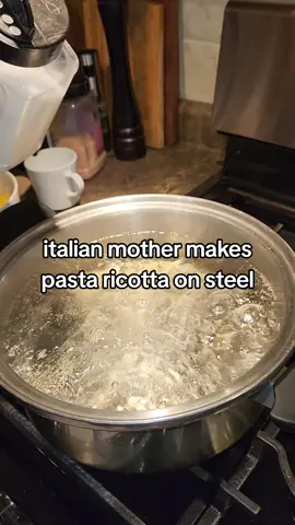 italian mother makes pasta ricotta on stainless steel. 
