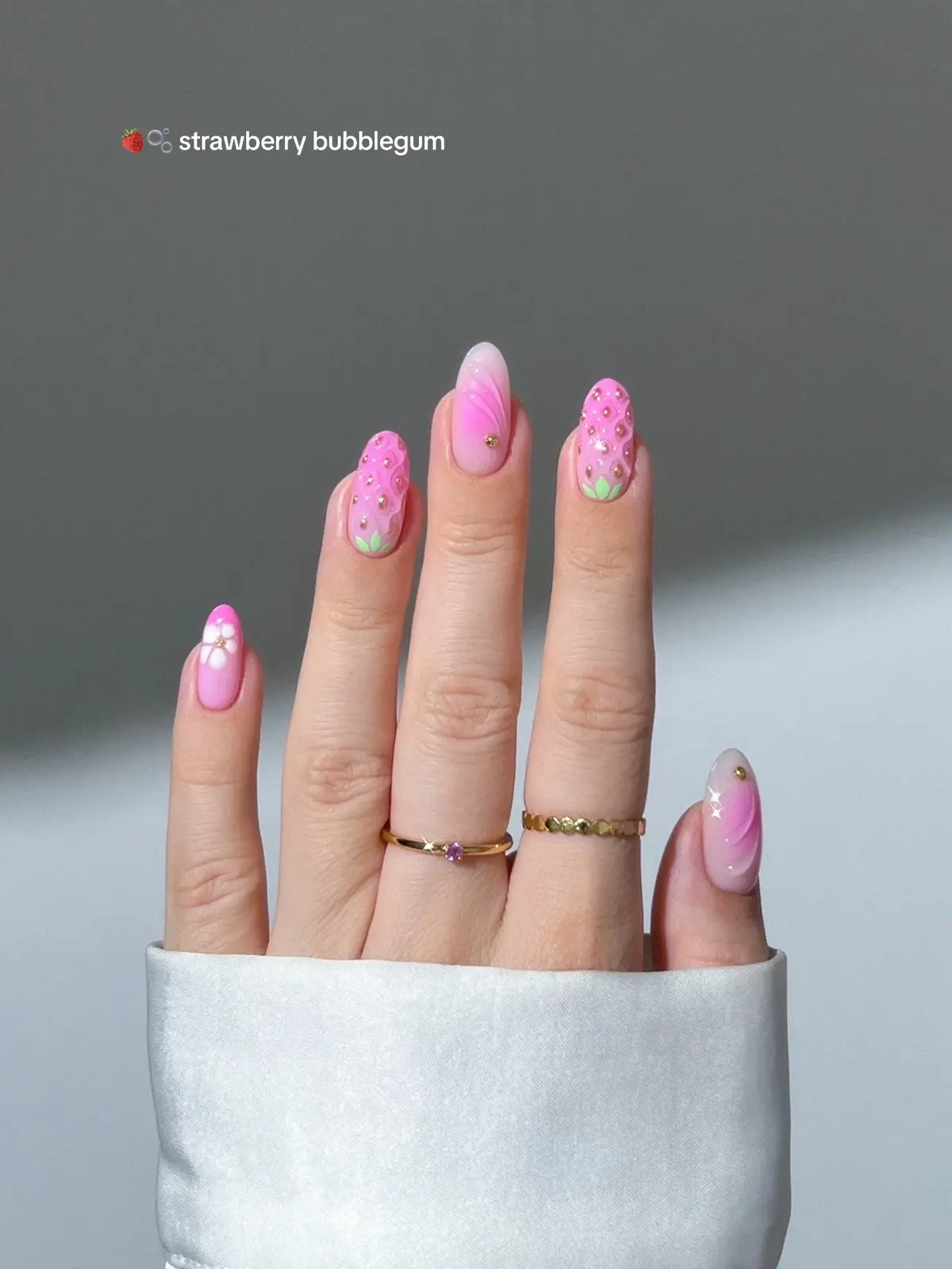 🍓🫧🌸🪻 pink strawberry treat and bubblegum sweetness, flowers in full bloom,  and a touch of cool blue breeze ✨🧊 _____  #strawberrynails #pinknails #glitternails #nails #nailart #summernails #nailinspo #vacationnails  3D nails, almond nails, nail art tutorial, french nails, shiny sparkly nails classy simple nails colorful nails aura ombre gradient flower floral nails pink purple lilac orange peach yellow blue bright nails , gold nails,   