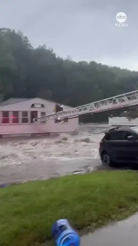 Dramatic video shows a fire engine ladder serving as a bridge across rushing floodwaters in Oxford, Connecticut, as firefighters helped rescue some 19 people and a dog stranded in a restaurant. As much as 10 inches of rain fell on some parts of western Connecticut, coming down so fast that it caught drivers unaware as roads quickly turned into rushing rivers. #flood #connecticut #weather #news #abcnews