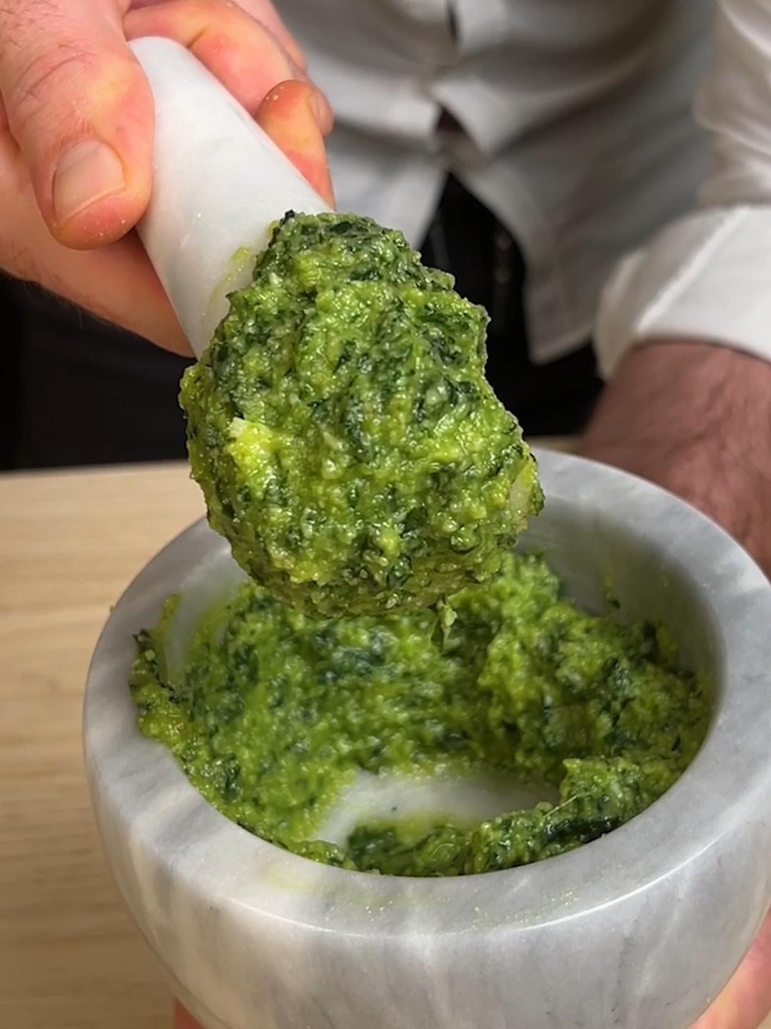 🍃Why buy it when it’s so easy and fun to make yourself? Our Elpidio will show you how to make the perfect Italian pesto in a few steps 🔥💪   👉INGREDIENTS 70g of basil 70g of extra virgin olive oil 50g of parmesan 30g of pecorino 30g of pinenuts 2 garlic cloves 3g core sault   👉METHOD 1. In a mortar (or a blender) squeeze the garlic and the salut. 2. Add the pinenuts, keep mixing and make a paste. 4. Add the basil leaves, first wash them, and dry them properly. Keep mixing making rotation movements.  5. When it's creamy add pecorino and parmesan, and mix again. 6. Add the olive oil and create a smooth and creamy texture. 7. Pour your pesto in the pasta and mix well, add some pasta water while mixing to make it extra creamy 8. Your fresh and delicious pesto is ready! What pasta would you eat with this #pesto? 😋👇 #cookistwow #cookistrecipe #pesto #basilpesto #homemade #pasta #italianrecipe #foodtok