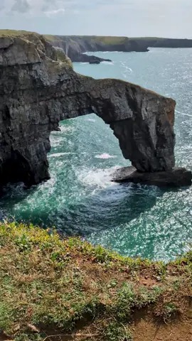 The Green Bridge of Wales is a natural, limestone rock arch formation found at Castlemartin near Pembroke. Around 66 feet long and 80 feet high, it's the covering of vegetation on its surface that gives rise to the name.  #bridge #naturalbridge #Wales #southwales #coast #explorewales #visitwakes #travellife 