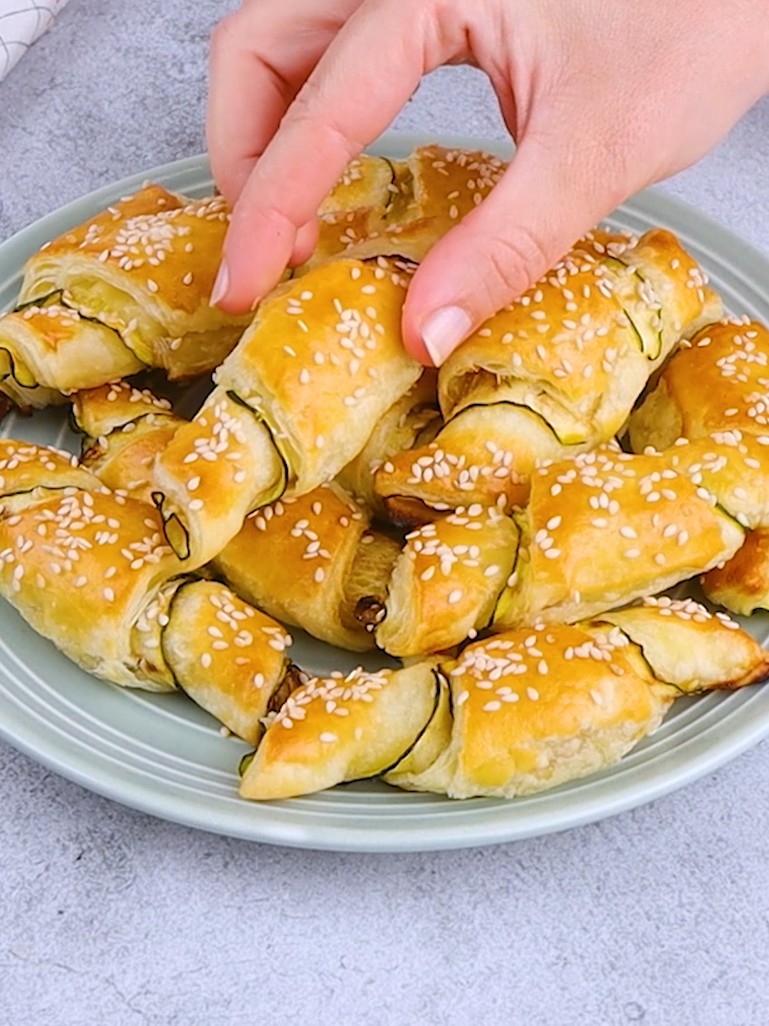 ZUCCHINI CROISSANTS reelThese #zucchini #croissants are the perfect solution for a tasty and quick appetizer that everyone will love! 😋❤️ The recipe is easier than you think 🙌 👉INGREDIENTS 3 zucchini 1 roll of puff pastry 60g (1/4 cup) of herbs cream cheese Egg for egg wash Sesame seeds 👉METHOD 1. Wash the zucchini and cut them into slices lengthwise. Transfer them to the grill pan and grill them on both sides. 2. Roll out the pastry on a cutting board and divide it into 12 pieces. Spread on each wedge of cream cheese. 3. Arrange two slices of grilled zucchini on each side on which the cream cheese is spread. Roll up the pastry to obtain a croissant shape. 4. Transfer zucchini croissants to the baking tray covered with parchment paper. Brush them with egg and sprinkle with sesame seeds. 5. Transfer zucchini croissants to the oven and bake at 190°C/375°F for 25 minutes. 6. Serve them all together on a serving dish and enjoy. What other ingredients can you make these with? 👇 #cookistwow #zucchini #appetizer #ideas #cooking #baking #homemade #foodtok