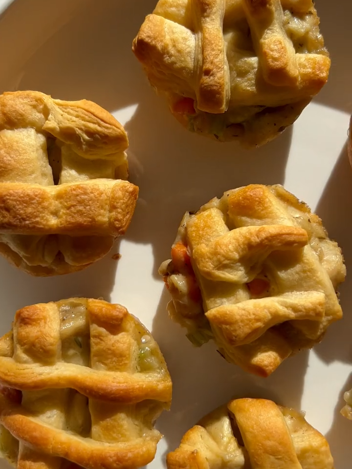 Need an easy dinner for fall that is super cute? These Mini Chicken Pot Pies make the best comfort food. They are such a fun dinner idea that comes together in minutes thanks to leftover rotisserie chicken and crescent roll dough! The shredded chicken is tossed with veggies in a homemade cream sauce then topped with flaky crescent dough. Kids will love these! Follow Chef Savvy for more fall recipes! #minipies #chickenpotpies  #easydinnerrecipes #comfortfoods #fallrecipes #rotissseriechicken