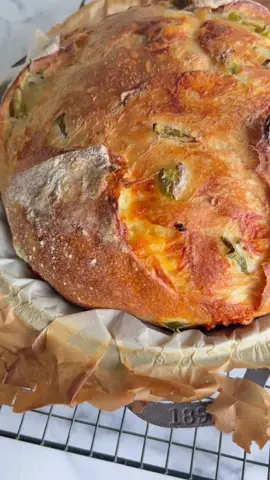 Jalapeño Cheddar Bread 🧀🌶️ 390ml warm water 1 teaspoon (5g) honey, sugar or agave 1 Tablespoon (15ml) extra virgin olive oil 1.5 teaspoons (6g) instant yeast 500g white bread flour (4 cups) 2 teaspoons (10g) fine sea salt 140g (1 heaping cup) mature cheddar cheese, cut into small cubes  125g (1 cup) pickled jalapeños, drained and roughly chopped Mix dough. Wait 15 mins. Stretch + fold (add half the jalapeños and cheese). Stretch + fold add second half jalapeños and cheese). Cover and proof at room temperature for 1.5 hours. Preheat oven with cast iron pot inside - 250C/480F. Shape dough and then rest (covered with bowl) for 30 mins while the pot preheats. Score, bake with lid on for 40-45 mins. Cast iron pot or Dutch Oven should be at least 4.7 litres/ 5 quarts. Bigger than this is great too. Cool completely before cutting in, enjoy! NOTE: If you don't have a cast iron pot, you can bake this bread on a baking tray. Just be sure to put a baking dish with hot water in the bottom of the oven as it preheats. Additionally, you can get a spray bottle and spray a few good pumps of water into the oven before closing the door for the bread to bake. The steam helps the bread to rise to its full potential before the crust forms. Bake the bread at 220C/430F for 30 minutes and then turn the temperature down to 210C/410F and carefully remove the hot water steam source from the oven. Continue baking for another 10-15 minutes or until the bread is golden brown and sounds hollow when you tap the bottom of it. #breadtok #jalapenocheddarbread #breadbaking #asmr #asmrfood #breadtutorial #asmrcommunity #breadrecipe #foodporn
