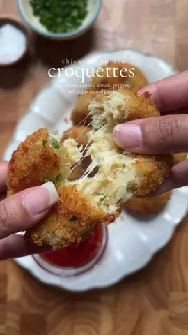Chicken and Potato Croquettes  Servings: 12-15 Ingredients: 1 lb boneless, skinless chicken breast, boiled and shredded 4 large potatoes, boiled and shredded 1/2 cup carrots, finely diced and boiled 1/2 cup bell pepper, finely chopped 1 cup mozzarella cheese, shredded 1 large egg 3 tbsp cornstarch Salt, to taste 1 tbsp black pepper 1 tbsp garlic powder 1 tbsp onion powder 1 tbsp chicken powder 2-3 Serrano peppers, finely chopped 1 tbsp fresh parsley, chopped Oil, for frying Coating: 1 cup bread crumbs 1/2 cup all-purpose flour + 1/3 cup water (to make thick slurry) Instructions: 1. In a large bowl, combine potatoes, chicken, carrots, Serrano peppers, bell peppers, egg, cornstarch, salt, pepper, garlic powder, onion powder, chicken powder, and cheese. Mix until well combined and sticky. 2. In a separate bowl, mix flour and water to form a thick paste. 3. In another bowl, add bread crumbs. 4. Shape potato-chicken mixture into round croquettes. 5. Coat croquettes in:  Flour mixture  Bread crumbs 6. Choose cooking method:  - Freeze for later use.  - Or heat oil in a pan once the oil is hot turn the heat to medium. Drop in the croquettes and Fry for 2-3 minutes flipping sides or until golden brown and crispy. Do not over crowd the pan.  - If Air frying,  lightly spray the croquettes with cooking oil and Air fry at 400°F (200°C) for 10 minutes, flipping halfway. Tips and Variations: - Freeze croquettes for up to 2 months. - Adjust Serrano pepper quantity to desired spiciness. - Experiment with different cheese combinations. #croquettes #chickenandpotatoes #crispypotatoes #recipes #SnackTime 