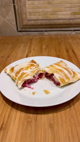 EASY HOMEMADE TOASTER STRUDELS!! INGREDIENTS:  >> 1st flavor (blueberry) * 1 package puff pastry sheets * 1 heaping cup fresh blueberries (or raspberries; 2 cups if doing all 10 pastries) * scant 1/3 cup white sugar (1/2 cup if doing all 10 pastries) * 2 teaspoons cornstarch  * 1 teaspoon lemon juice  >> 2nd flavor (fruit jam of choice) * 1/2 cup jam (1 cup + 1 tablespoon if doing all 10 pastries with jam) * 1 teaspoon cornstarch (2 teaspoons if doing all 10) *** CREAM CHEESE FILLING: * 4 ounces cream cheese (softened) * 1/3 cup powdered sugar *** EGG WASH: 1 egg + 1 tablespoon water ***CREAM CHEESE GLAZE: * 2 tablespoons softened cream cheese * 1 tablespoon butter * 1 cup powdered sugar * 3 1/2 to 4 tablespoons milk DIRECTIONS: > Take frozen puff pastry sheets out of freezer and let thaw. Bring cream cheese to room, temperature, and butter. Recipe can be done making only one type of fruit or jam,or 2.   > Preheat oven to 400° > Chop blueberries. Mix in microwave safe bowl with cornstarch, sugar, and lemon juice. Cover and microwave for two minutes and 20 seconds. Will thicken. > Mix Cream cheese filling. Spoon filling into piping bag or sandwich baggie. Seal, and cut cut off tip. > Mix egg wash  > Lightly flour surface. Roll out one sheet puff pastry to large rectangle. Use pizza cutter, and cut into 10 equal rectangles. Place 6 rectangles on parchment paper, or greased cookie sheet. Put spoonful of blueberry mixture in the center of each rectangle (don’t go too closely to the edges).  > Squeeze strip of cream cheese down center of fruit. Repeat. Place rectangle pastry on top. Use fork to seal all four edges. Brush with egg wash repeat.  Use fork & poke tops 5 to 6 times.  > Place cookie sheet in preheated oven and bake 22 to 25 minutes until golden brown.  >>> Make second set of four pastries. Mix jam with 1 teaspoon cornstarch.  Repeat steps  above.  (jam mixture, cream, cheese mixture, seal edges, egg wash, and poke holes) > While baking make cream cheese glaze. Remove from oven when golden brown.  Drizzle with glaze.  ENJOY!!!  #strudel #toasterstrudel #pastry #puffpastry #glaze #creamcheeseglaze #creamcheese #blueberry #blueberries #raspberry #raspberries #Foodie #baking #easybaking #BakeWithMe #bakewithmimi #dessert #breakfast @Philly Cream Cheese @Pepperidge Farm 