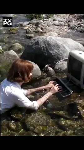 Lady using a computer outside in water #computer #outside #water #river #lake #pond #rocks #memes #meme 