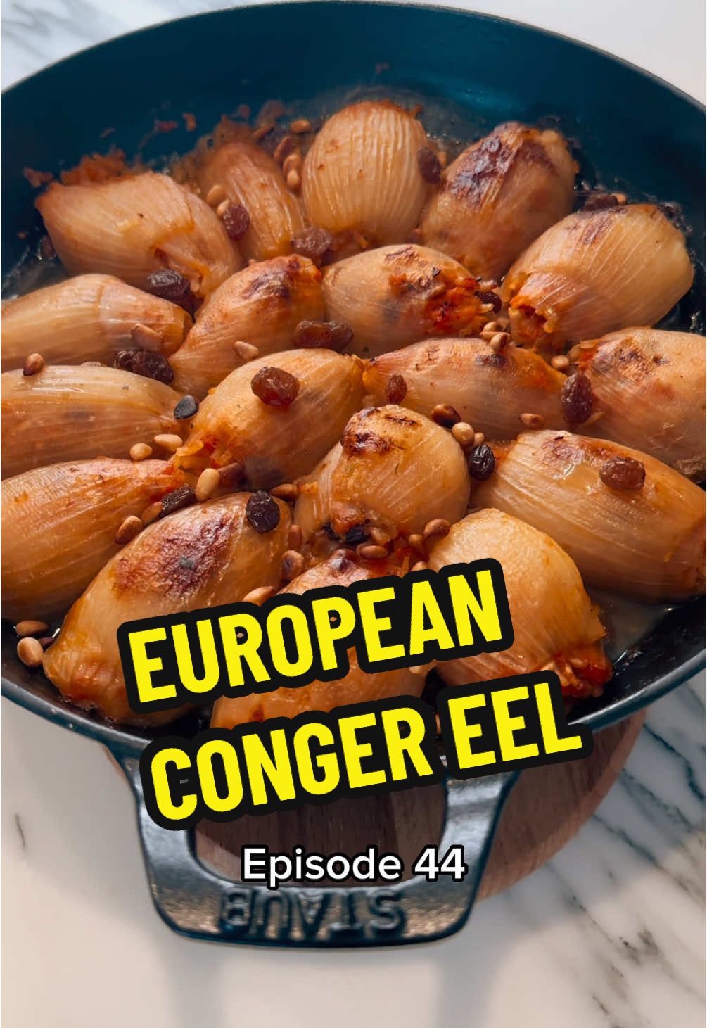 COOKING EVERY FISH IN THE WORLD 🐟 🌍  Episode 44 - European Conger Eel • BIN: Conger conger FR: Congre / anguille de mer GER: Meeraal IT: Grongo ESP: Congrio CRO-SRB: Ugor •  Truth be told, all props and recognitions for this recipe go to @Ma’ayan | itsvegansis I was initially going to make a classic Catalan fish recipe „pescado con pasas y piñones“ (fish with raisins and pine nuts), when I stumbled across her unbelievably delicious recipe for stuffed onions and decided to literally copy & paste her recipe 😅. The result is the ultimate pescatarian comfort food dish! Happy conger eel sourced from Fin & Bone London , vegetables from @Andreas . The silent star of the show, my magnificent cast iron frying pan, has been lovingly crafted by @STAUB USA & @busterandpunch 🔥. • Ingredients (serves 4): 500g cleaned conger eel meat (or monkfish) 6 onions 500g tomato passata 4 garlic cloves  80ml brandy 300ml fish or vegetable stock 30g raisins 30g roasted pine nuts 150g paella rice Pinch of chili powder  • Recipe: 1. Fillet the fish as shown in this reel. 2. Poach the fish for 5 minutes, chill, pick all the pin bones and crumble the flesh. 3. Cut and blanch the onions as shown in the video. Peel the first 3-4 layers and chop up the rest. Sweat down the chopped onions, add garlic and tomato. Cook gently until you get a „Sofrito“. Deglaze with brandy. 4. Combine the sofrito, poached fish, pine nuts, raisins, rice and chilli powder and mix well. Stuff the onion layers, arrange in a deep dish, cover with hot stock and backe with a cartouche at 180C for 30 minutes. Remove cartouche and finish cooking until golden, approximately another 30 minutes. Enjoy! • #comfortfood #homecooked #pescatarian #conger #fishrecipe #familydinner 