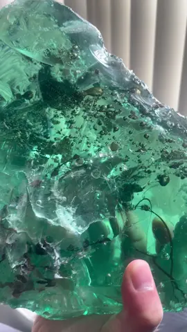 Green obsidian is a rare and mesmerizing volcanic glass known for its vibrant, translucent green hue. Often called the 