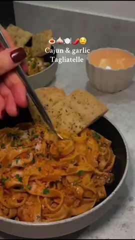 Cajun & garlic tagliatelle 🍝🧄🌶️🍽️🫶  This one is honestly too good 🤤🤤🤤  Ingredients  - Tagliatelle  - 2 chicken breast  - Salt & pepper  - 1tsp oregano  - 1tsp garlic granules  - 1tbsp Cajun seasoning  - 2tbsp paprika  - Fry light  - Lazy or fresh garlic  - 150ml chicken stock  - Light elmea double cream  - 10g chopped parsley  - 50g Parmesan cheese  - Chilli flakes  Step 1 - dice your chicken breast and add to one bowl, then season with salt, pepper, garlic granules, paprika, Cajun seasoning & oregano and mix  Step 2 - dice white onion and chop parsley, then add chicken stock to bowl with 150ml of boiling water  Step 3 - add water and salt to pot, then bring to boil and add your tagliatelle  Step 4 - spray pan with some fry light and add your chicken from bowl until cooked  Step 5 - add garlic and your diced onion to the pan and let that cook until onion is translucent  Step 6 - add in your chicken stock and let it cook for around 2 mins, add in the double cream, paprika and Cajun seasoning, tomato puree and mix, then allow sauce to thicken for a few minutes  Step 7 - take pasta of boil and drain  Step 8 - to the same pan add in some Parmesan cheese and your chopped parsley ( keep some of both to top plate with once dished up )  Step 9 - add pasta to same pan and combine everything together  Step 10 - dish up and top with some Parmesan, parsley & chilli flakes  #easydinners #quickmeals #tagliatelle #cajungarlictagliatelle #glasgow #whatimadefordinner #fyp #easypastadinner #DinnerIdeas #cajunandgarlictagliatelle #ciaraxcooks #verylazygarlic 
