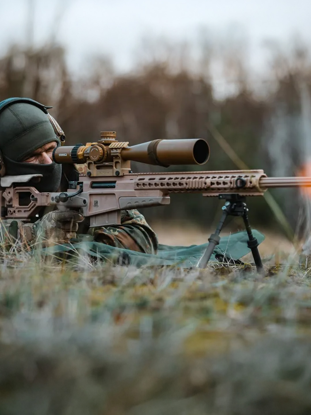 The G22A2 sniper rifle offers enhanced precision with a telescopic sight, night vision, and a muzzle brake that reduces recoil, perfect for long-range and night operations.