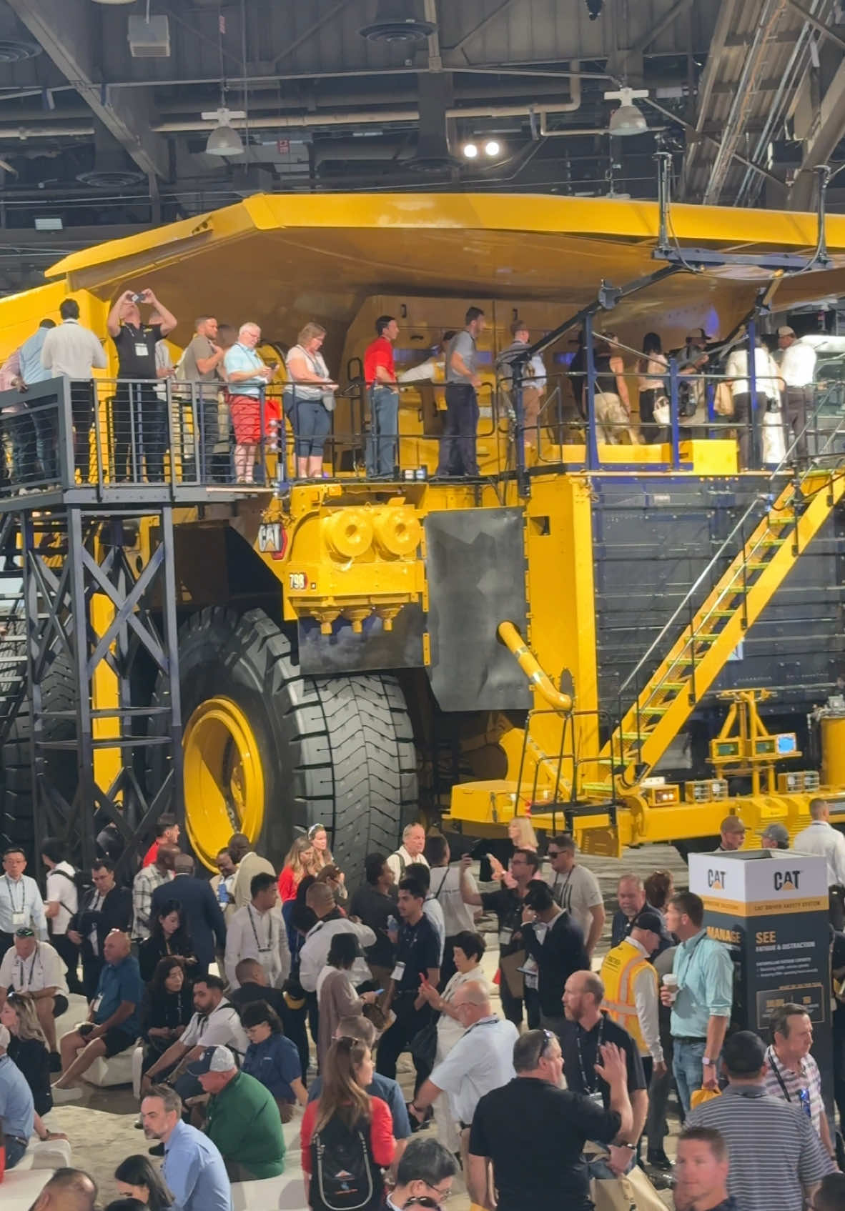 Crowds on the Cat stand at MINExpo 2024 around the 24 grader and 798AC truck.  #heavyequipment #mining #cat798ac #dumptruck #grader 