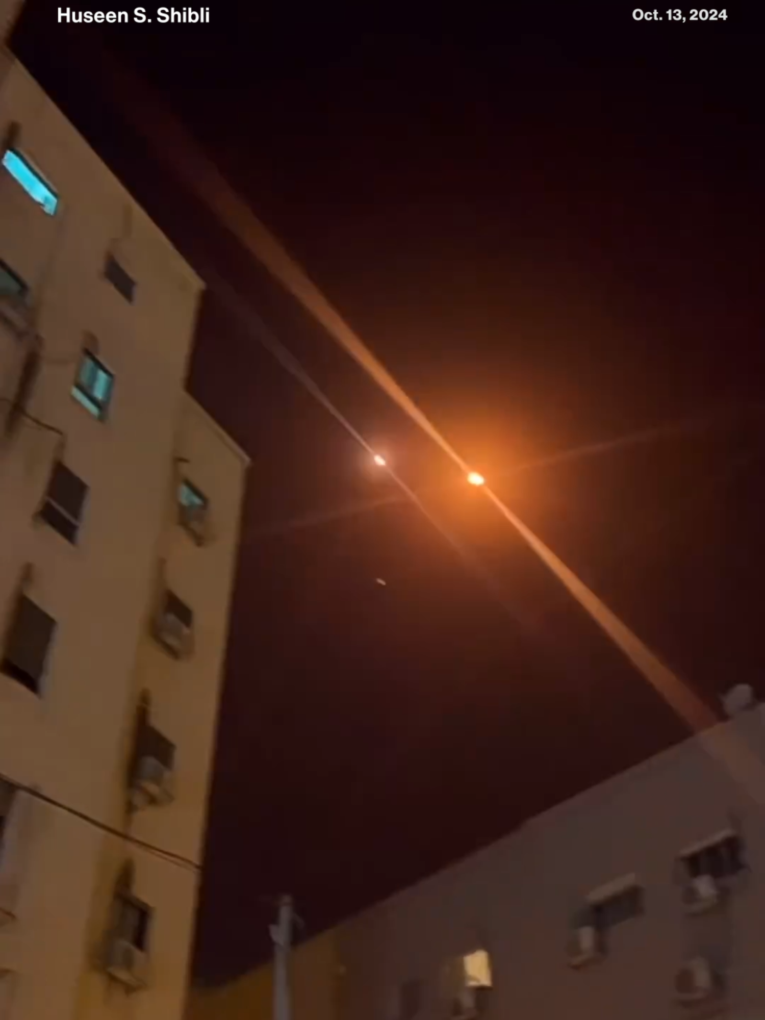 Video shows young men watching multiple interceptions in the sky over northern Israel on Sunday evening. They can be heard saying in Arabic 