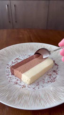 Triple Chocolate Bavarois…. Recipe Below 6Tbsp filtered water 15g gelatin powder 375ml whole milk 8 egg yolks 45g caster or granulated sugar 140g white chocolate 140g milk chocolate 140g dark chocolate 720ml heavy cream -Combine gelatin and water, mix and let sit in a pot on the stove with no heat -Add milk to a pot, bring to a boil while stirring -Combine egg yolks and sugar, whisk well -Pour over milk, stir until completely mixed. Pour mixture back into pot -Cook on stove over low heat while stirring constantly until a custard forms -Pour the custard in 3rds over each type of chocolate -Stir chocolate until melted and smooth -Whip cream until very soft peaks -Heat gelatin, add 2Tbsp to the white chocolate -Stir until almost set, fold in 1/3 of the cream -Layer into an oiled loaf pan with parchment along the bottom -Let set in the fridge for 15-20 minutes -Repeat the process for the milk, and dark chocolate -Once the final layer is on, let the whole dessert sit and chill in the fridge for at least 1 hour to fully set -Dip the pan very briefly in boiling water to help remove -Turn onto a cutting board and slice with a hot knife -Serve with chocolate shavings. Enjoy. Recipe by the phenomenal @prueleith  Cookware: @mauviel.1830.usa  Stove: @subzeroandwolf  Whisk: @dreamfarm  #food #Foodie #foodies #Recipe #recipes #Receta #comida #dessert #pastry #chocolate #bavarois #darkchocolate #milkchocolate #whitechocolate #dessertinspo #sweet #sweettooth #homecooking #homerecipe #easydessert #easydesserts #easydessertrecipe #dessertideas #chocolatedessert #chocolatecake #naplesflorida #naplesfl #naplesprivatechef #privatechef #naples