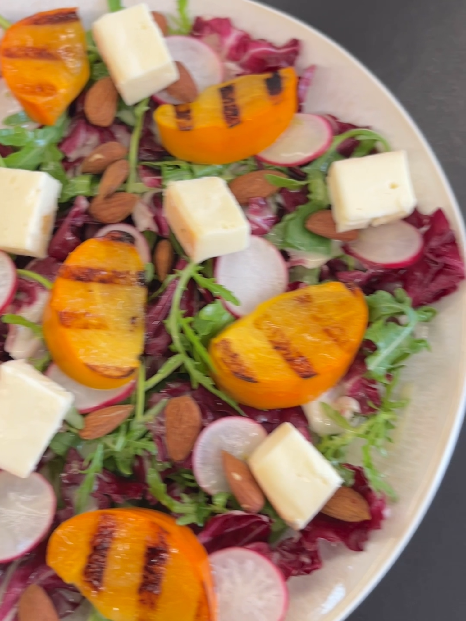 Add a touch of citrus magic to your fall salad! 🍂🥗 Try this Grilled Persimmon Salad with a zingy Mapo Vinaigrette for a refreshing twist🌟🍊 Grilled Persimmon Salad with Mapo Vinaigrette Ingredients for the Salad: 2 persimmons, cut into wedges 4 cups arugula (100 g) 1/2 head radicchio, chopped and soaked in warm water for 10 minutes 1 to 1 1/4 cups soft cheese, cut into small pieces (150-200 g) 4-5 radishes, thinly sliced 1/4 cup toasted almonds (30 g) Ingredients for the Mapo Vinaigrette: Zest of 2 mapo (mandarin hybrid citrus) Juice of 2 mapo 1 tablespoon vinegar 1 teaspoon grated ginger 3 tablespoons extra virgin olive oil Instructions: Prepare the vinaigrette by blending the zest and juice of the mapo, vinegar, ginger, and olive oil until smooth. Grill the persimmon wedges for a few minutes until slightly caramelized. Drain and dry the radicchio, then toss it with the arugula and arrange on a serving plate. Add the radishes, grilled persimmons, cheese pieces, and toasted almonds. Drizzle the salad with the mapo vinaigrette and serve. #giallolovesitaly #giallozafferano #recipes