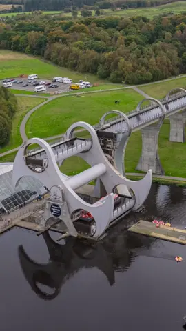 The famous Falkirk Wheel at Tamfourhill, Falkirk which quickly links together the Union Canal and the Forth and Clyde Canal.  Did you know that the 2 canals used to be linked previously further east at Lock 16 in Camelon?  The 2 canals were linked by a complex series of 11 traditional locks which took the best part of a full working day to navigate.  This link between the canals was abandoned in the 1930s and built over, although you can still see remnants of the old locks if you know where to look.  The Falkirk Wheel re-linked the canals when it was built over 22 years and allows passage between the canals in minutes rather than hours! #falkirk #visitfalkirk #canal #canalmagic #Scotland #visitscotland #drone #timelapse 