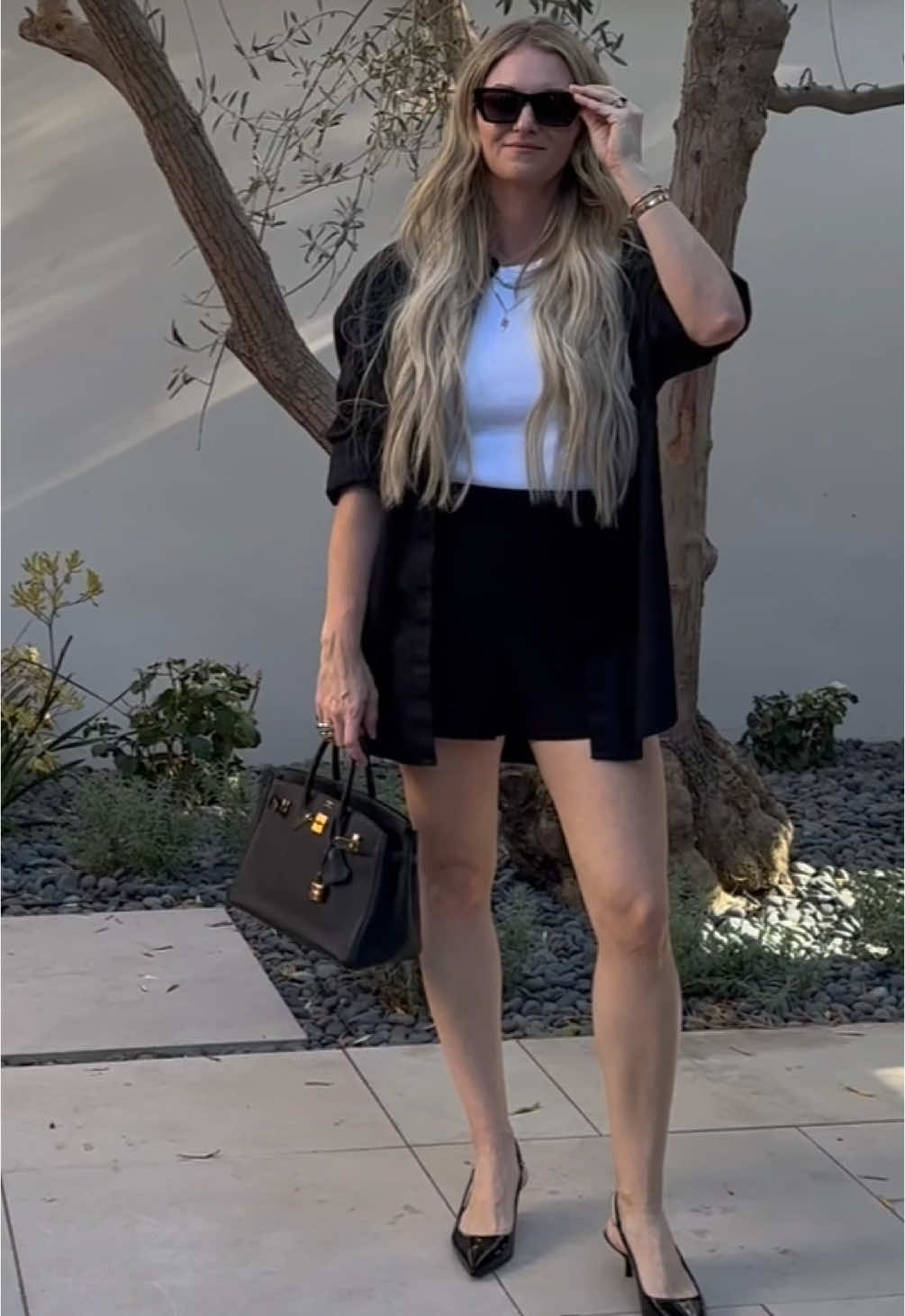 The perfect date night outfit. I wanted something casual and, of course, BLACK!  I’ve been loving the large oversized button up shirts and I paired this one with my high waisted fave shorts!  PS how can a girl really resist the chain detail on the backs of these @Gucci Slingbacks. Easy sell honestly   Follow my shop @erinccummings on the @shop.LTK app to shop this post and get my exclusive app-only content! #liketkit #LTKStyleTip #LTKShoeCrush #LTKFindsUnder100 @shop.ltk https://liketk.it/4TCX2