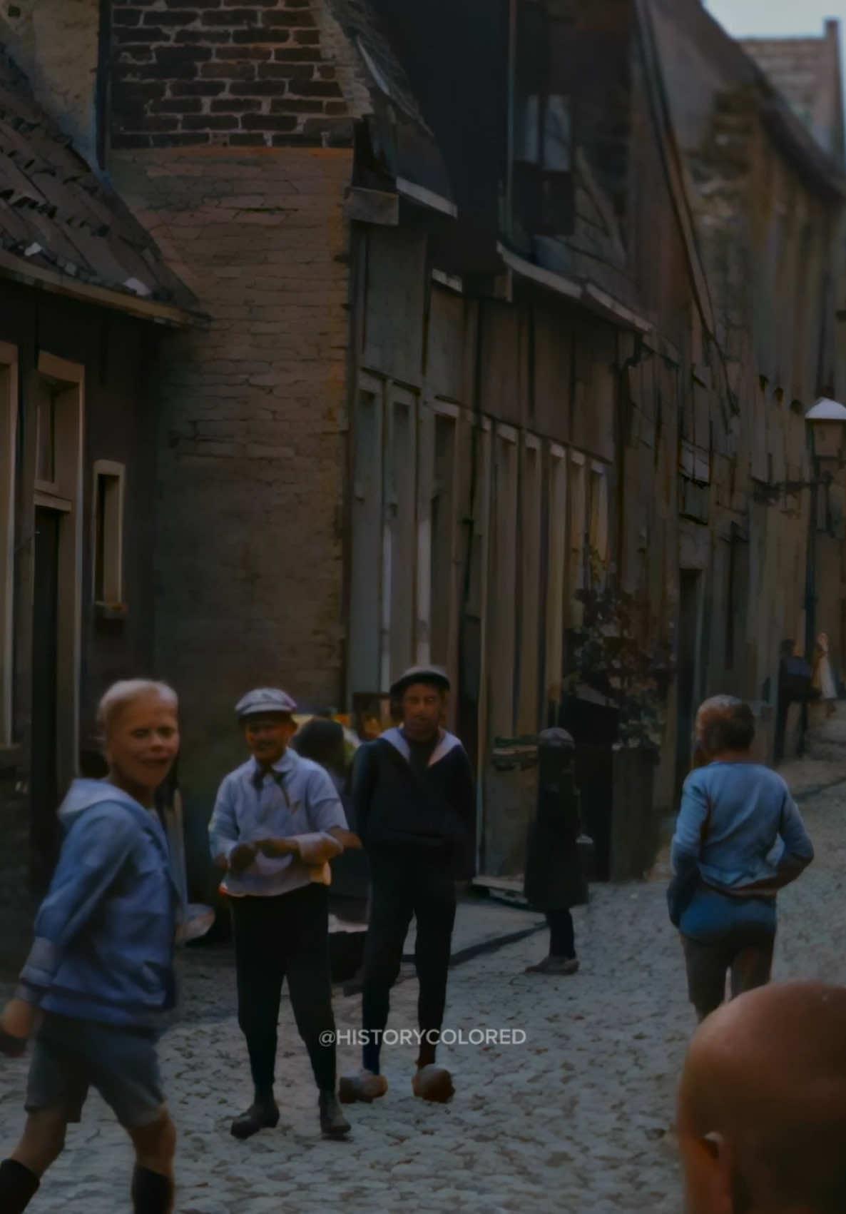 Restored footage from 1919 of a group of children playing on the street in Groningen, the Netherlands. - Footage frame rate increased, upscaled and “colorized” by HistoryColored using AI technology.  - Footage originally from: Stadsgezichten van Groningen, OpenBeelden, Public Domain - #history #groningen #netherlands #restored #historicalfootage