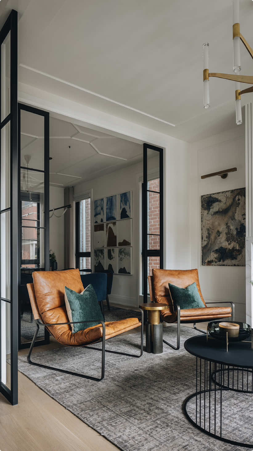 Serving up comfort with a side of cocktail hour—this front living room has it all! 🥂 From buttery, leather accent chairs to velvet throw pillows and custom drapery, this space is styled for relaxation with sophistication. The low-back sofa is not just chic, it’s a favorite perch for the family dog to watch the city life pass by! And with a cluster of coffee tables around the fireplace, there’s plenty of space to set your drink (and avoid wagging tails!).  Bonus: Admire the stunning artwork by Chicago’s own Matt Nguyen framing the warm, fluted fireplace. This space radiates style, warmth, and personality! Project: #DGIUrbanRefinement #DGIdesignbuild #chicagointeriordesigner #HomeInspiration #LivingRoomDesign #CocktailHourStyle #CozyLivingSpace #InteriorElegance #HomeDecorInspo #CityLivingStyle #LuxuryInteriors #ChicLivingRoom #ModernHomeDesign #CustomDrapery #LeatherAccentChairs #VelvetThrowPillows #FireplaceDesign #ChicagoArt #InteriorDesignDetails