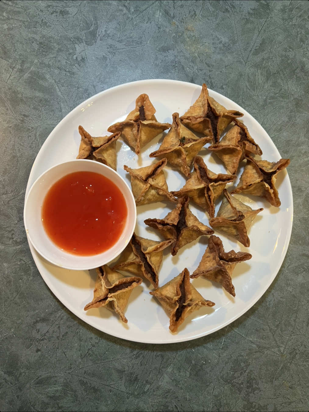 Crab Rangoon . . . Ingredients: 6 oz cream cheese, 6 oz imitation crab (or real if you want), 1 tbsp onion powder, 1 tbsp garlic powder, 1 tbsp dark soya sauce, 1 tbsp sesame oil, 1 tsp chilli oil, 1 tsp Worcestershire, green onion, mag, wonton wrappers. . . The crab rangoons, again. I changed the recipe up a little bit! I definitely think this one is much better!  . . Also… this recipes (post last year) is my most viewed video on TT… now you know 😂  . . . #fyp 