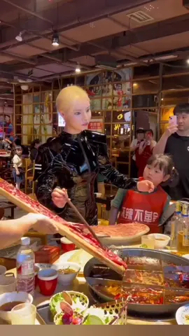 Ms. Qin: (real person, hyperrealistic actor) 26-year-old restaurant owner from Chongqing, China, has taken the world by storm with her unique blend of grace & performance. At her hotpot restaurant, she mesmerizes diners with robotic movements, a disciplined gaze & impeccable poise that defies the ordinary. 🤖 Step into a world where elegance practice meets at its highest level. Ms. Qin glides through her restaurant, each movement a calculated dance that captures the essence of modern sophistication. Amidst a symphony of flashing cameras & captivated smiles, she brings a touch of robotic allure to every table, embodying the harmony of human creativity & performance. Video credit @asian_tecnology #human #AI #realistic #robot #repost