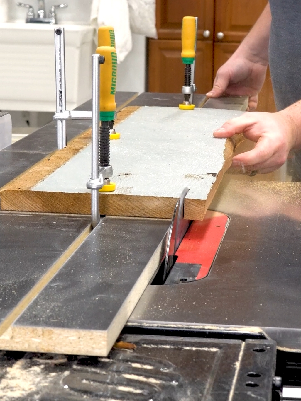 Edge jointing without a jointer using this jig I made for my SawStop ICS table saw, all tools used in the video are available on our website. There is a straight edge of the jig that rides along the fence, the material is clamped down with the edge you want to joint overhanging the side of the blade using the MicroJig MatchFit clamps to hold it securely in place. I then cut that edge with the Amana Tool PR1040C 10